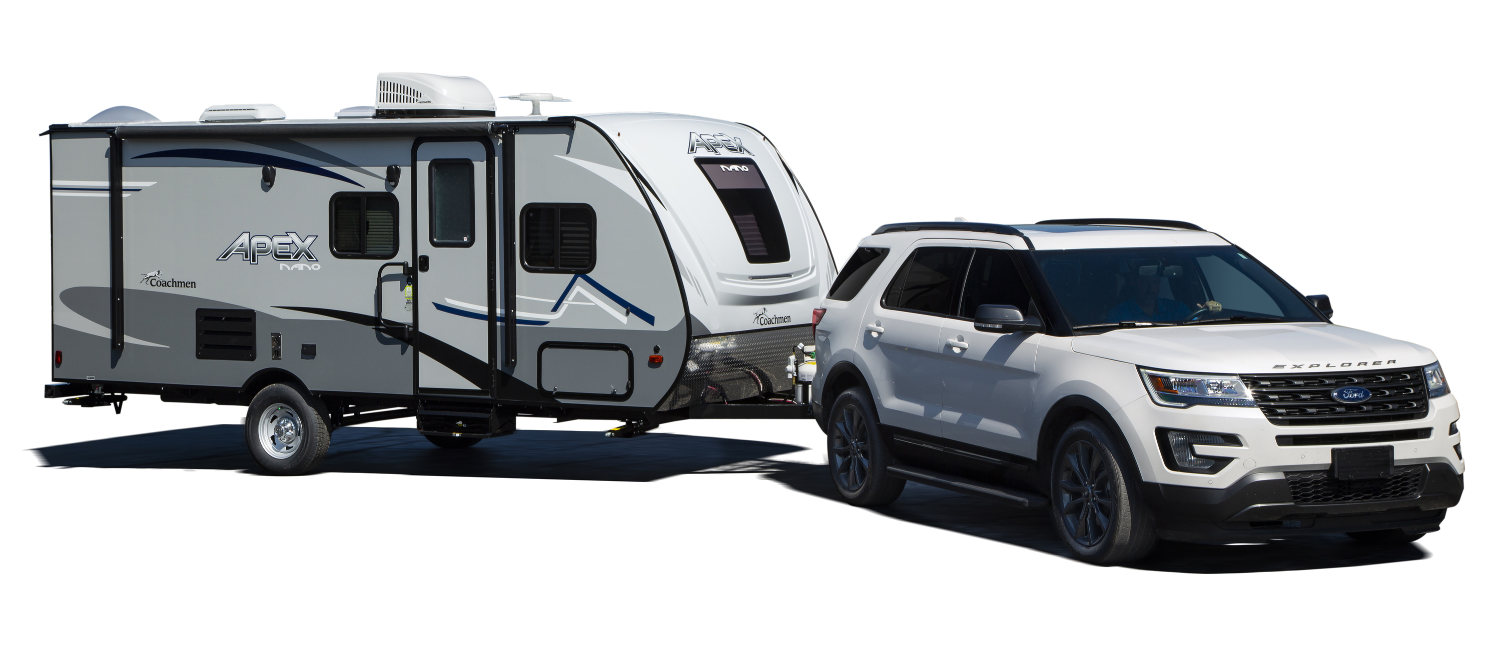 Car towing a travel trailer against a white background